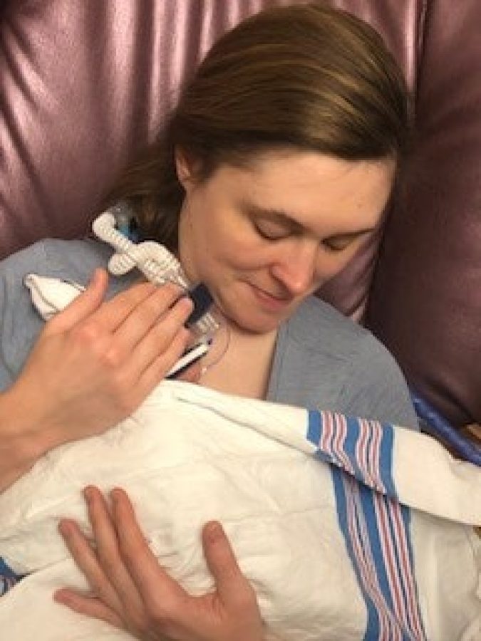 Caroline's mother holding her in a chair