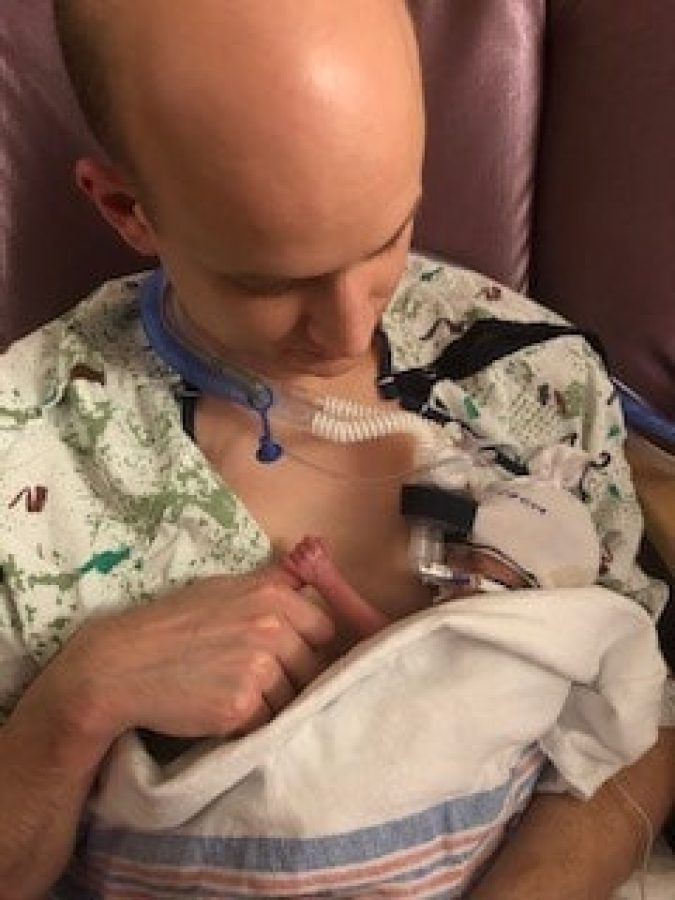 Caroline's father holding her in a chair