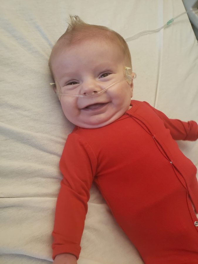 Image of Ryder in a red sweater smiling