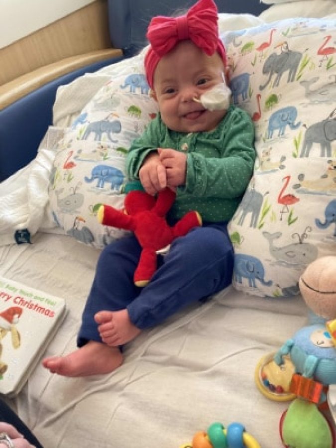 Image of Nora playing with her toy