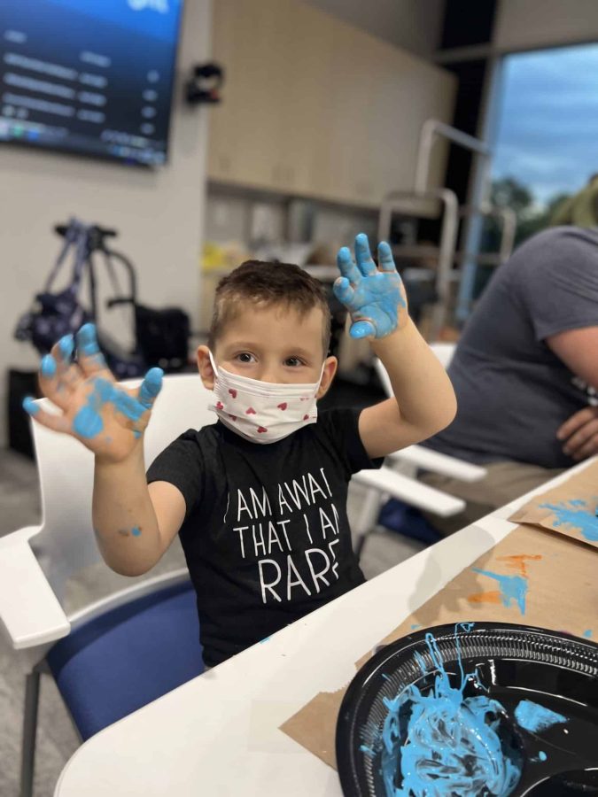 Image from Moments of Joy - Boy with paint in his hands