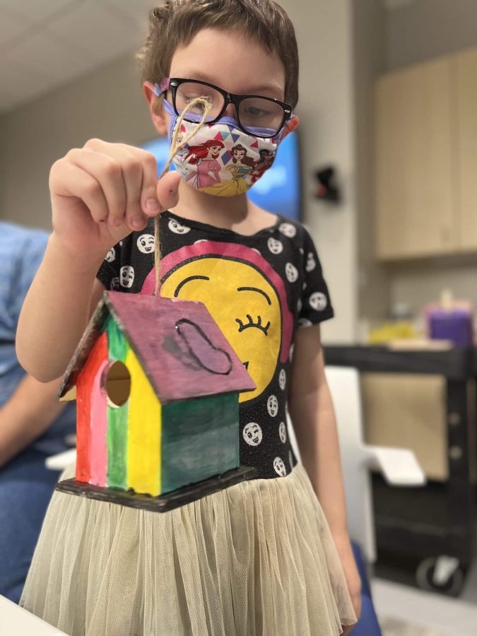 Image from Moments of Joy - Girl showing her painted house