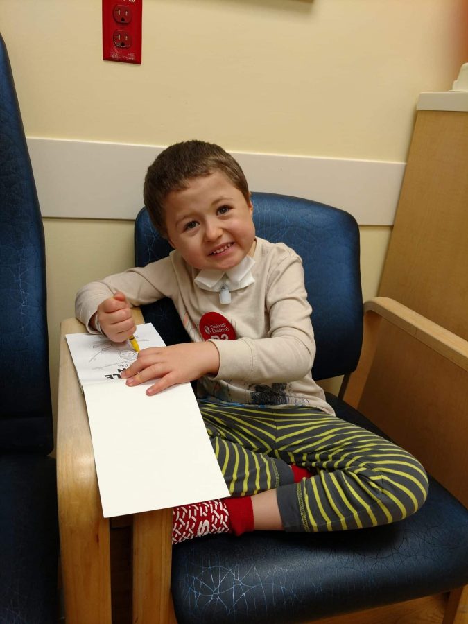 Image of Ash with a coloring book