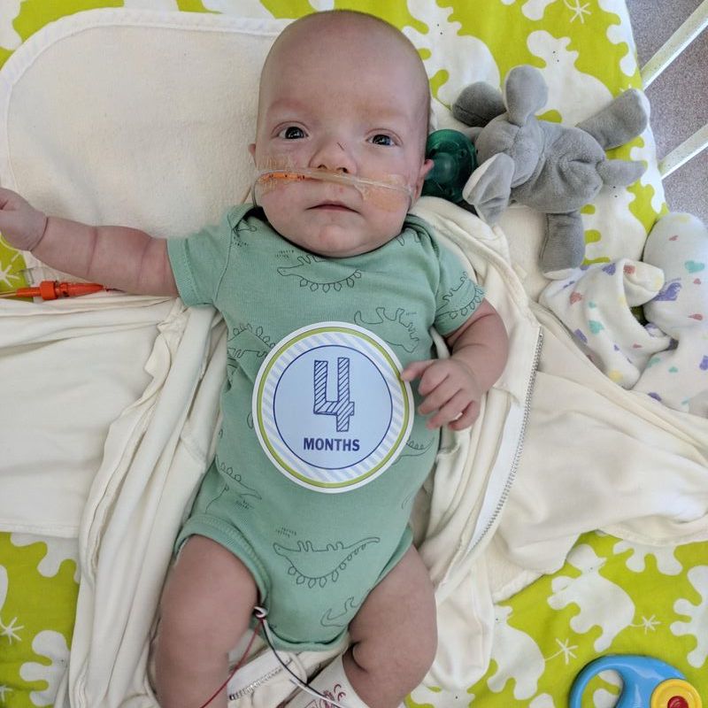 Picture of baby Elijah in the hospital wearing a four month old sticker.
