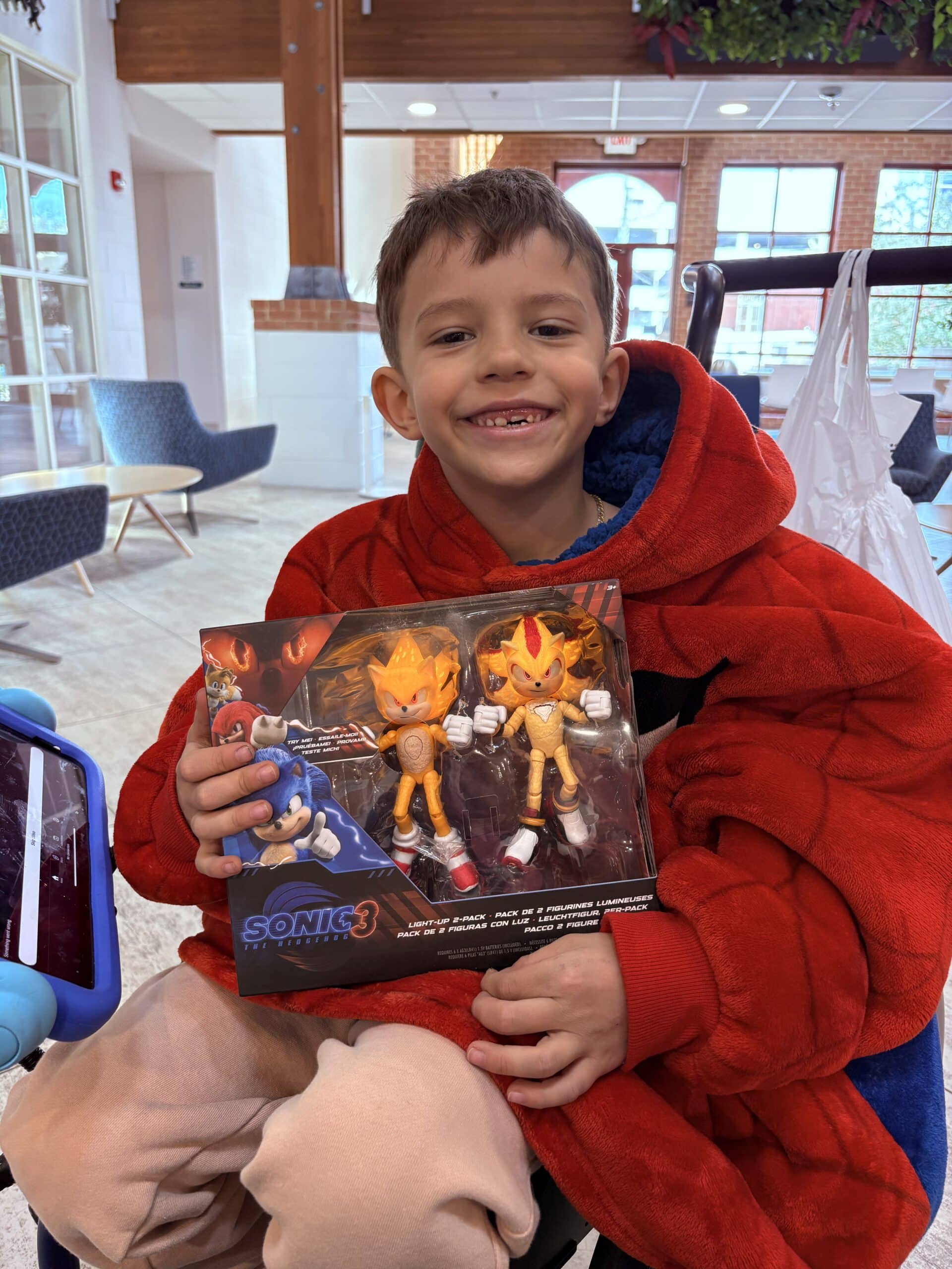 Boy holding a new toy.