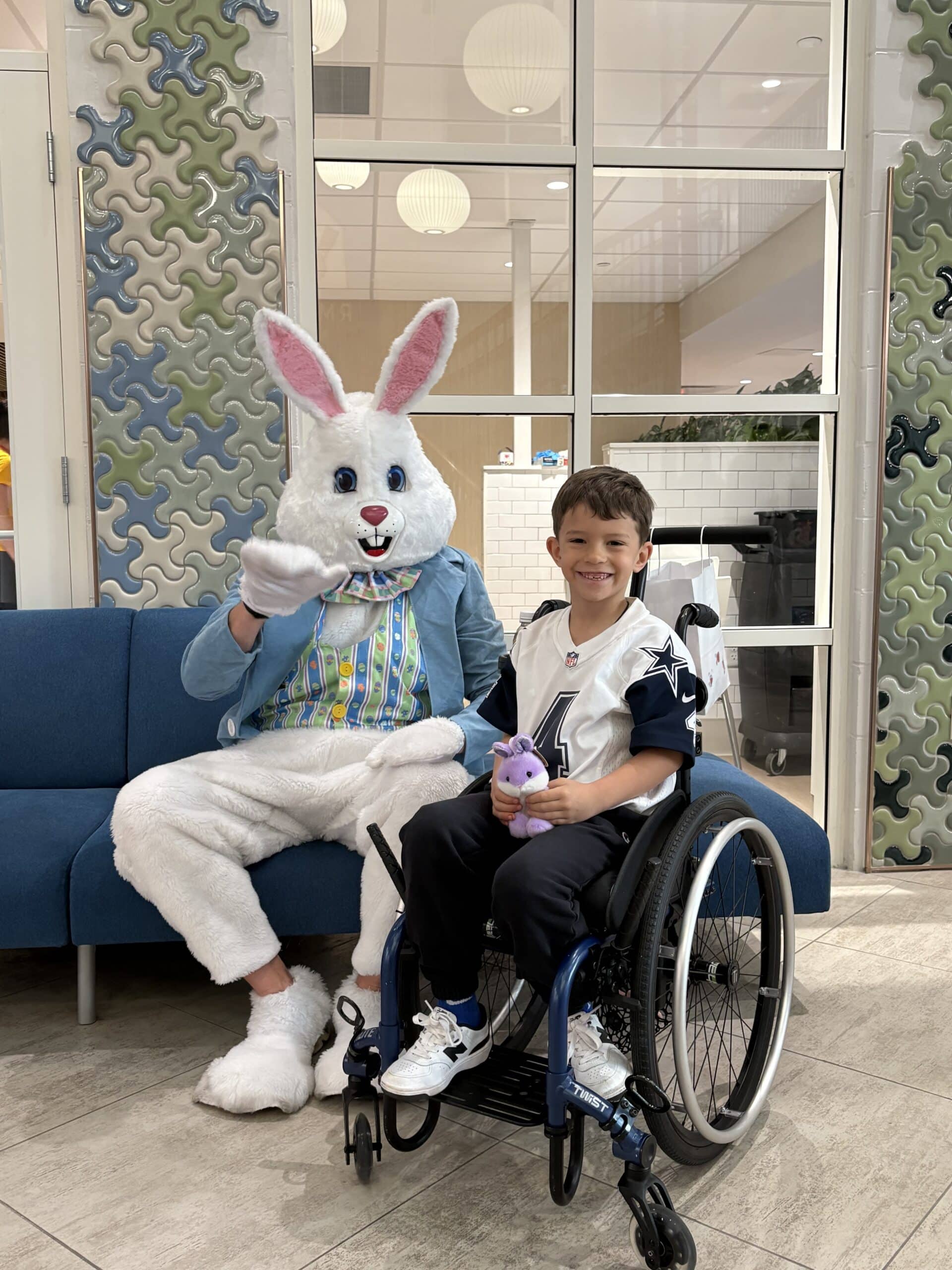 Boy posing with Easter Bunny.